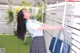 A woman in a school uniform holding a blue bag.