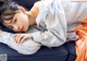 A woman laying on top of a blue couch.