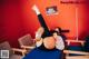 A woman laying on top of a blue table in a room.