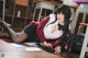 A woman in a school uniform laying on the floor.