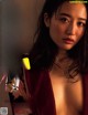 A woman in a red robe is posing for a magazine.